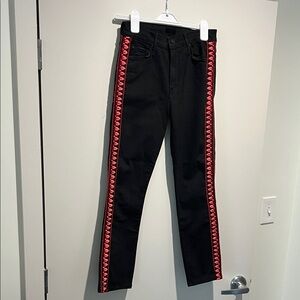 Black Mother Denim jeans with red embroidery on sides.
